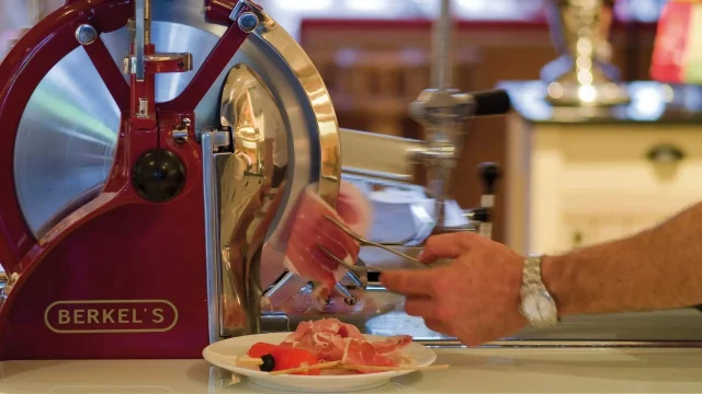 Händisches Schneiden von Wurst mit einer Maschinen