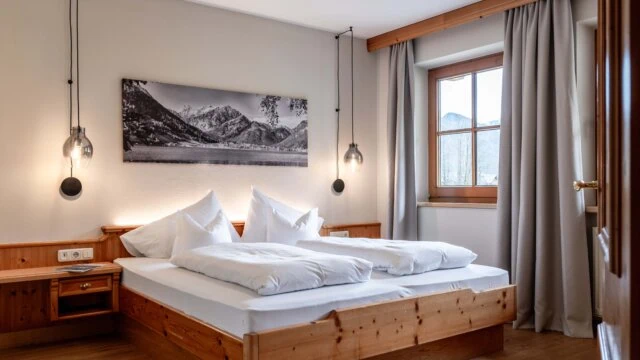 Gemütliches Schlafzimmer mit Doppelbett und Bergblick.