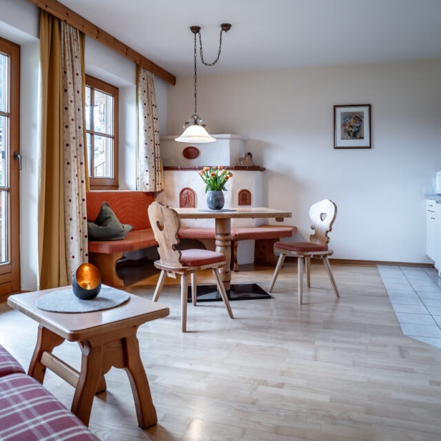 Helles Wohnzimmer mit Holzmöbeln und Küche